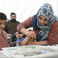 A family painting together at Art In The Parl